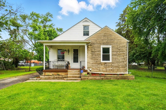 2506 Chester Rd, Columbus, OH 43231 - bungalow-style house featuring a porch, a front yard, and stone siding