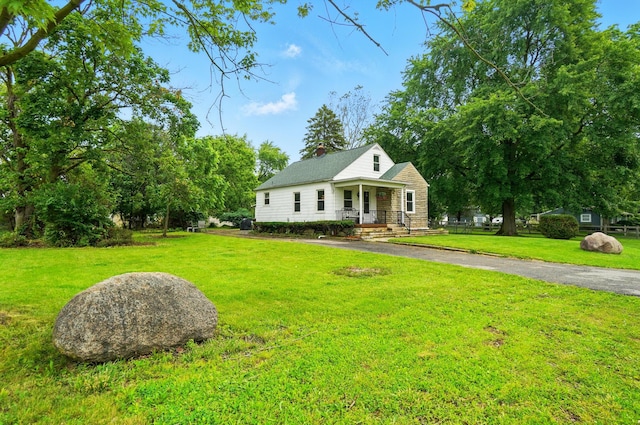2506 Chester Rd, Columbus, OH 43231 - view of front of house featuring a porch, a chimney, and a front lawn