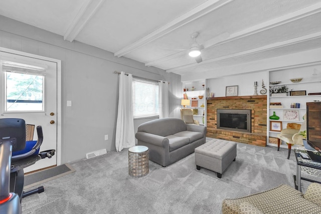 563 Wickham Way, Gahanna, OH 43230 - carpeted living room with beamed ceiling, a ceiling fan, and a fireplace