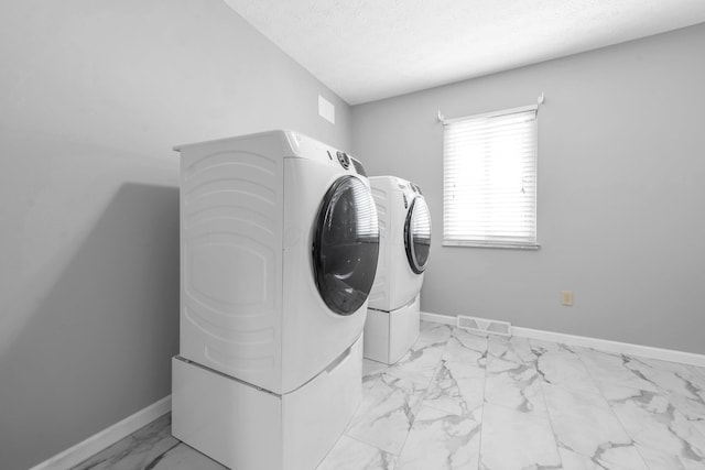 563 Wickham Way, Gahanna, OH 43230 - washroom with separate washer and dryer, light marble finish flooring, and a textured ceiling