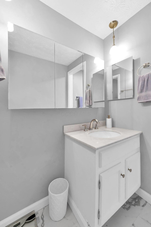 563 Wickham Way, Gahanna, OH 43230 - bathroom featuring marble look tile flooring, vanity, and a textured ceiling