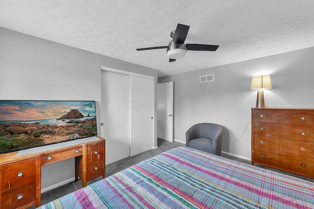 563 Wickham Way, Gahanna, OH 43230 - carpeted bedroom with a closet, a textured ceiling, a desk, and ceiling fan
