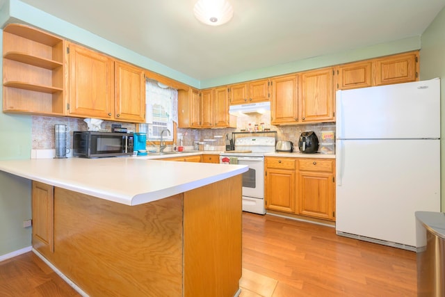 126 Holly Ln, Russells Point, OH 43348 - kitchen featuring white appliances, under cabinet range hood, tasteful backsplash, and a peninsula