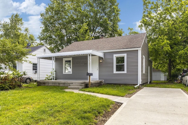 2592 Grasmere Ave, Columbus, OH 43211 - bungalow-style house featuring covered porch, a shingled roof, and a front lawn