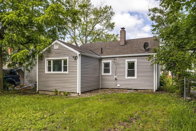 2592 Grasmere Ave, Columbus, OH 43211 - back of property featuring a chimney, a yard, and roof with shingles
