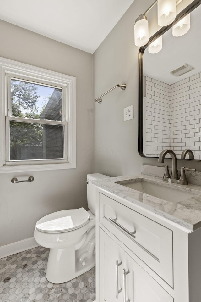 2592 Grasmere Ave, Columbus, OH 43211 - half bath featuring toilet, vanity, and baseboards