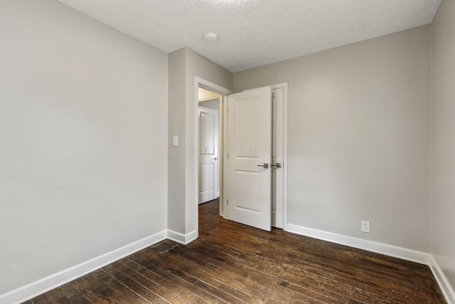 2592 Grasmere Ave, Columbus, OH 43211 - empty room with dark wood-style flooring, baseboards, a smoke detector, and a textured ceiling