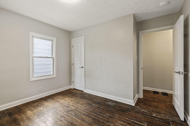 2592 Grasmere Ave, Columbus, OH 43211 - unfurnished bedroom with dark wood-style flooring and baseboards