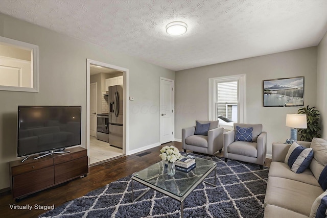 2592 Grasmere Ave, Columbus, OH 43211 - living room featuring wood finished floors, baseboards, and a textured ceiling