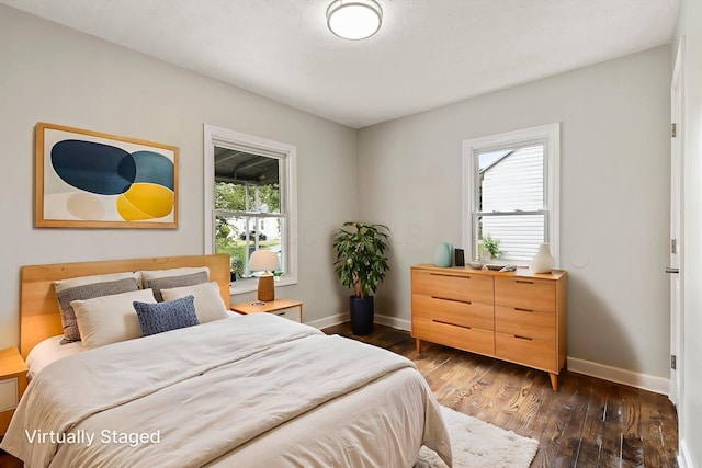 2592 Grasmere Ave, Columbus, OH 43211 - bedroom featuring baseboards, multiple windows, and dark wood-type flooring