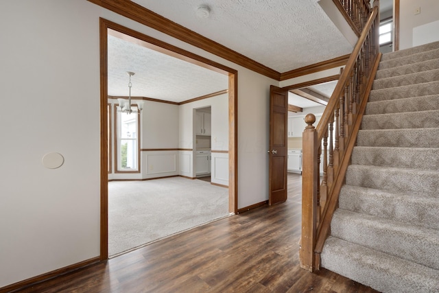 7552 Deer Creek Dr, Columbus, OH 43085 - staircase with ornamental molding, a textured ceiling, wood finished floors, a chandelier, and plenty of natural light