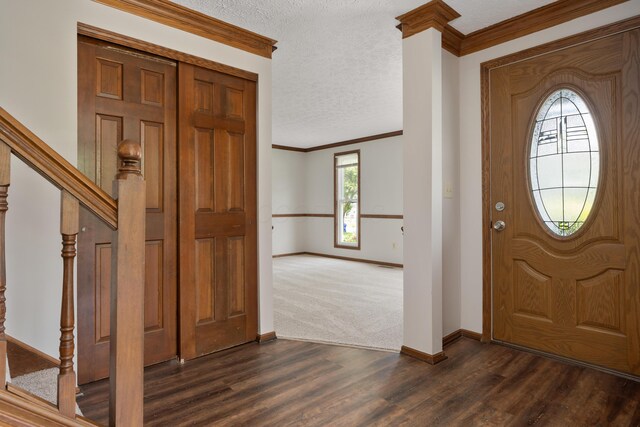 7552 Deer Creek Dr, Columbus, OH 43085 - entrance foyer with baseboards, crown molding, dark wood finished floors, a textured ceiling, and stairway
