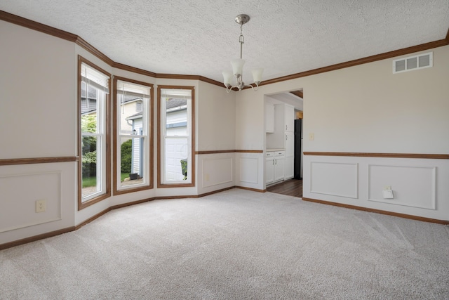 7552 Deer Creek Dr, Columbus, OH 43085 - carpeted spare room featuring a chandelier, ornamental molding, wainscoting, a textured ceiling, and a decorative wall