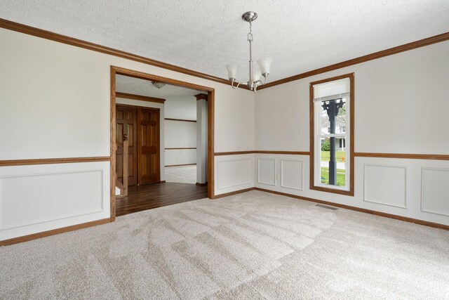 7552 Deer Creek Dr, Columbus, OH 43085 - carpeted spare room with a chandelier, a textured ceiling, a wainscoted wall, and a decorative wall