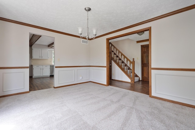 7552 Deer Creek Dr, Columbus, OH 43085 - unfurnished room featuring carpet flooring, stairway, a chandelier, wainscoting, and a decorative wall