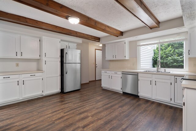 7552 Deer Creek Dr, Columbus, OH 43085 - kitchen featuring appliances with stainless steel finishes, a sink, dark wood-style flooring, white cabinets, and beam ceiling