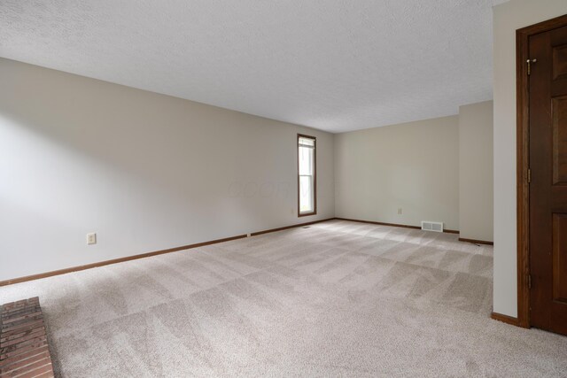 7552 Deer Creek Dr, Columbus, OH 43085 - empty room with a textured ceiling, light colored carpet, and baseboards
