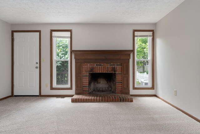 7552 Deer Creek Dr, Columbus, OH 43085 - unfurnished living room featuring carpet floors, a fireplace, baseboards, and a textured ceiling