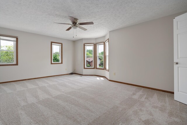 7552 Deer Creek Dr, Columbus, OH 43085 - spare room with healthy amount of natural light, light colored carpet, a ceiling fan, baseboards, and a textured ceiling