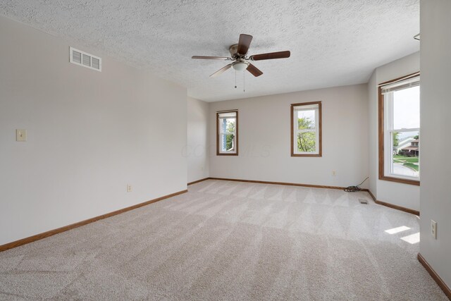 7552 Deer Creek Dr, Columbus, OH 43085 - empty room with light colored carpet, baseboards, ceiling fan, and a textured ceiling