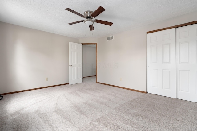 7552 Deer Creek Dr, Columbus, OH 43085 - unfurnished bedroom featuring light colored carpet, a closet, baseboards, ceiling fan, and a textured ceiling