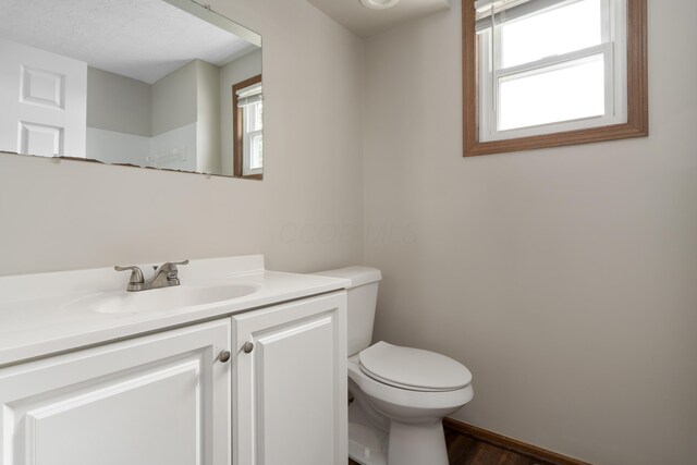 7552 Deer Creek Dr, Columbus, OH 43085 - bathroom featuring vanity, toilet, wood finished floors, and baseboards