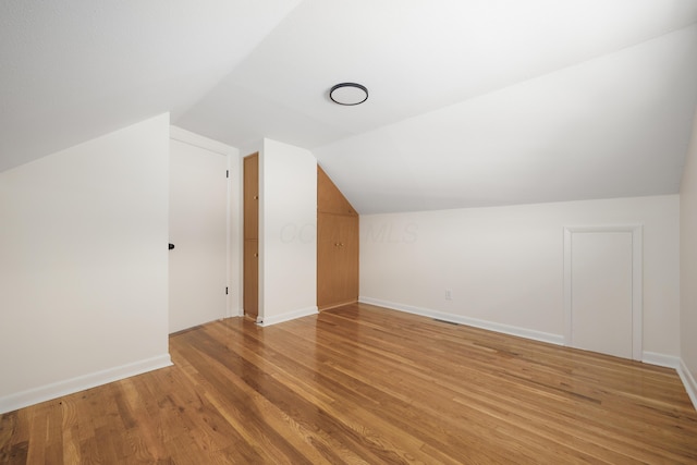 1079 Loring Rd, Columbus, OH 43224 - bonus room with lofted ceiling, light wood-type flooring, and baseboards