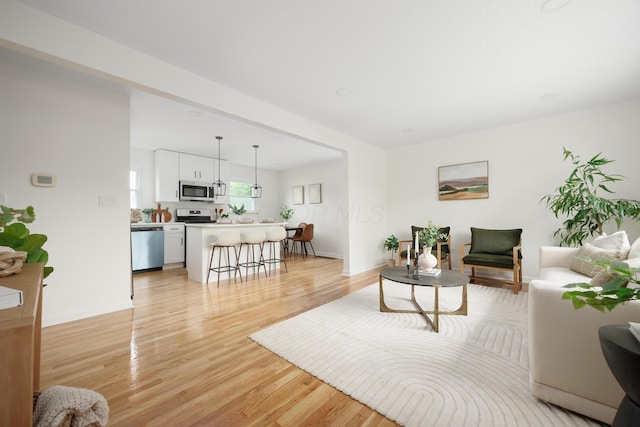 1079 Loring Rd, Columbus, OH 43224 - living area featuring light wood-style floors and baseboards