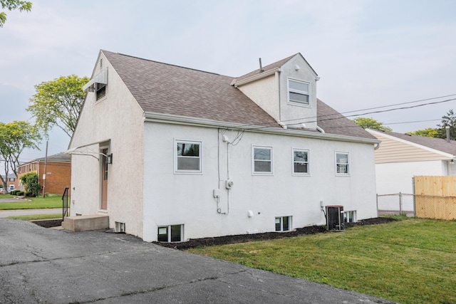 1079 Loring Rd, Columbus, OH 43224 - view of property exterior with a shingled roof, stucco siding, and central air condition unit