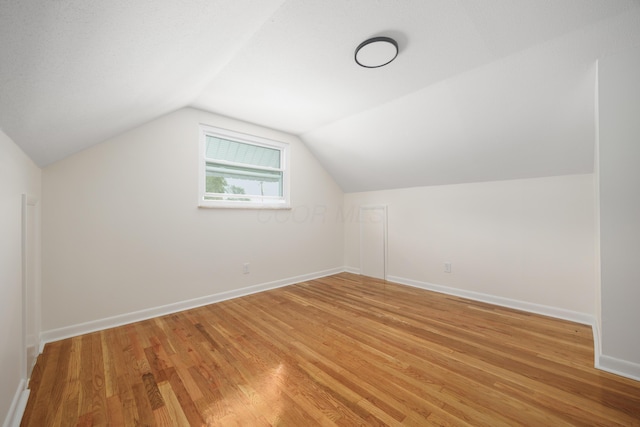 1079 Loring Rd, Columbus, OH 43224 - additional living space with light wood-style flooring, lofted ceiling, and baseboards