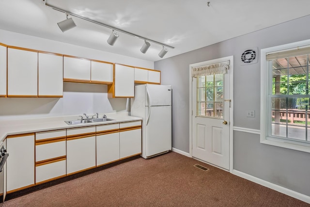 929 Fairwood Ave, Marion, OH 43302 - kitchen with freestanding refrigerator, rail lighting, light countertops, and white cabinetry