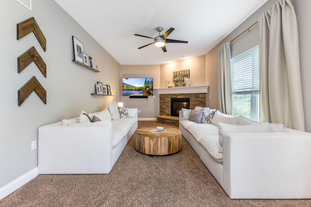 405 Tyler Station Dr, Johnstown, OH 43031 - carpeted living room featuring ceiling fan, baseboards, and a stone fireplace