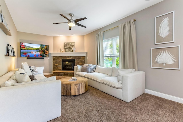 405 Tyler Station Dr, Johnstown, OH 43031 - living room with ceiling fan, carpet, baseboards, and a stone fireplace