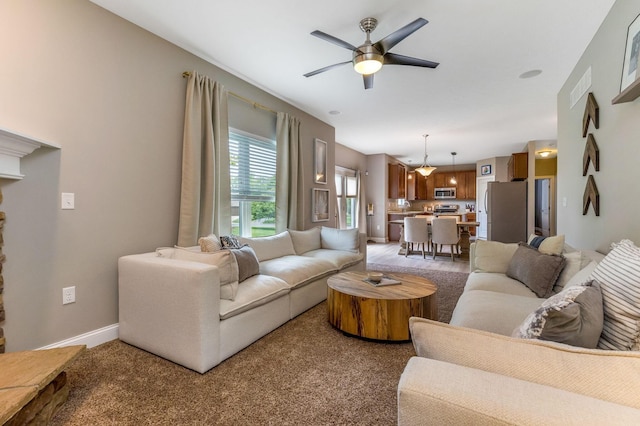 405 Tyler Station Dr, Johnstown, OH 43031 - living area featuring light colored carpet, ceiling fan, and baseboards