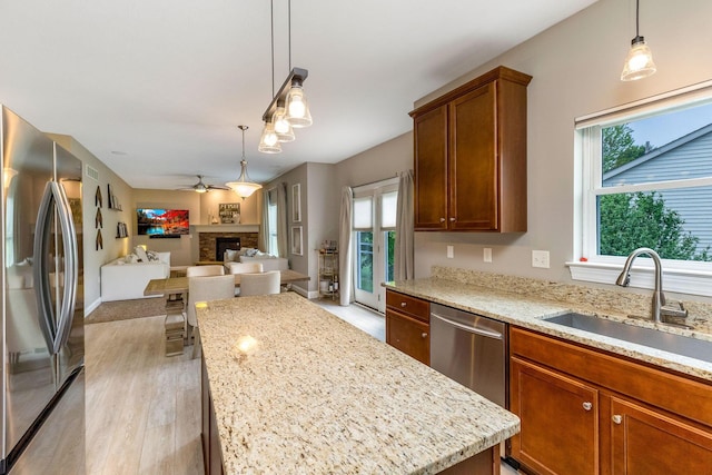 405 Tyler Station Dr, Johnstown, OH 43031 - kitchen with appliances with stainless steel finishes, a sink, a center island, open floor plan, and light wood-style floors