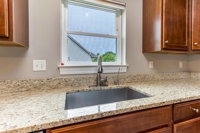 405 Tyler Station Dr, Johnstown, OH 43031 - kitchen with a sink, light stone countertops, and brown cabinetry