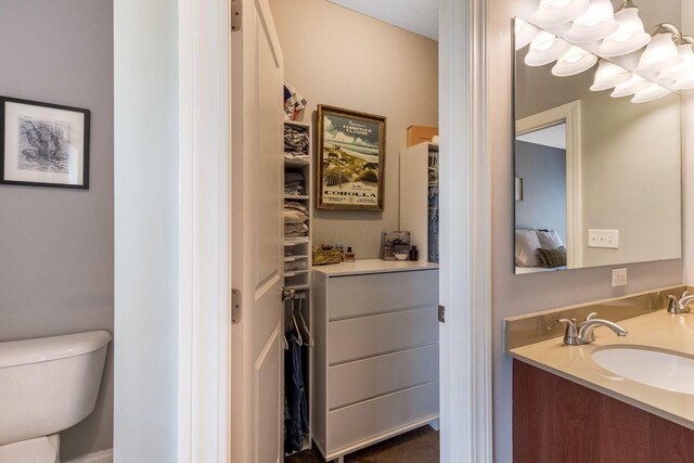 405 Tyler Station Dr, Johnstown, OH 43031 - bathroom featuring toilet, double vanity, a chandelier, and a closet