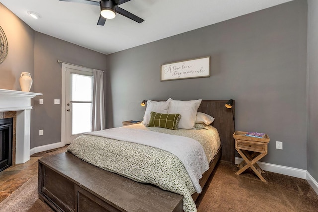 405 Tyler Station Dr, Johnstown, OH 43031 - bedroom featuring baseboards, a tiled fireplace, a ceiling fan, and carpet floors
