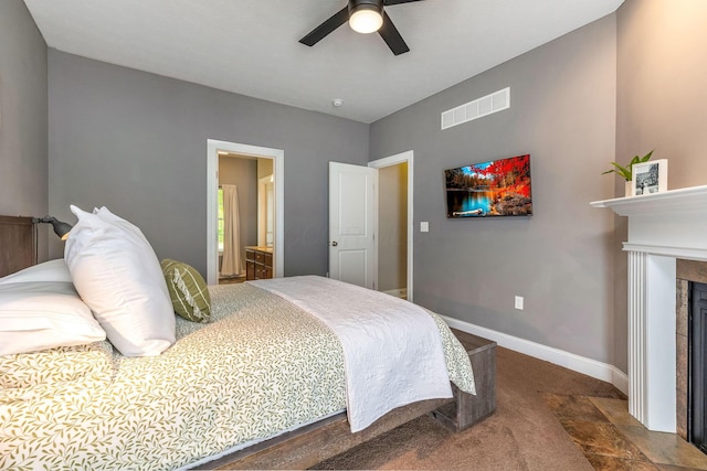 405 Tyler Station Dr, Johnstown, OH 43031 - carpeted bedroom featuring baseboards, a fireplace, ensuite bathroom, and a ceiling fan