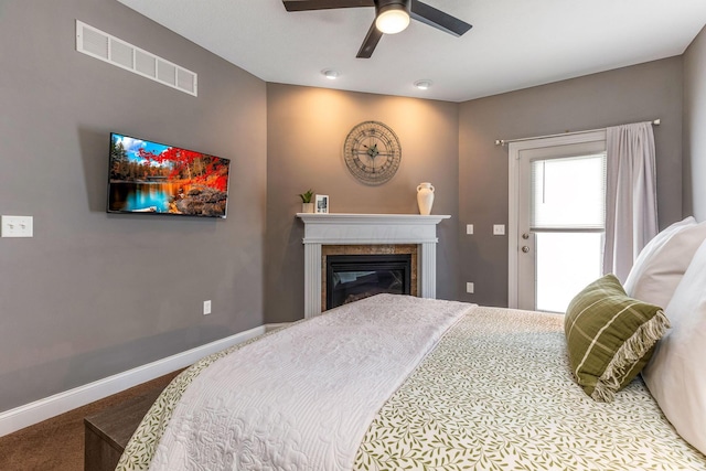 405 Tyler Station Dr, Johnstown, OH 43031 - bedroom with carpet, baseboards, a glass covered fireplace, and a ceiling fan
