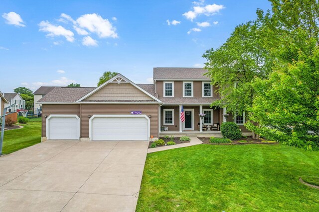 405 Tyler Station Dr, Johnstown, OH 43031 - view of front facade featuring a porch, an attached garage, a front lawn, concrete driveway, and roof with shingles