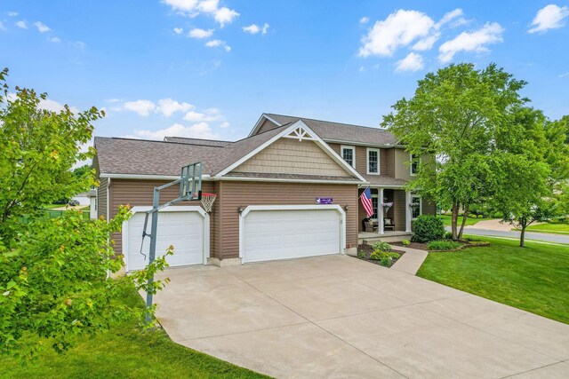 405 Tyler Station Dr, Johnstown, OH 43031 - craftsman house featuring a garage, concrete driveway, a front lawn, and roof with shingles