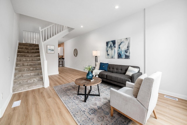 1116 Summit St Unit 1114, Columbus, OH 43201 - living room featuring wood finished floors, stairs, baseboards, and recessed lighting
