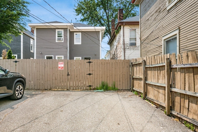 1116 Summit St Unit 1114, Columbus, OH 43201 - view of side of property featuring a gate, uncovered parking, and a chimney