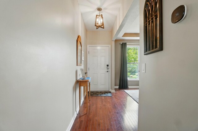 6368 Casado Dr, Columbus, OH 43213 - foyer entrance featuring a chandelier, dark wood-style flooring, and baseboards