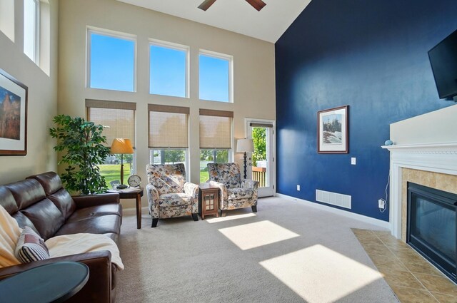 6368 Casado Dr, Columbus, OH 43213 - living room with high vaulted ceiling, a ceiling fan, a tiled fireplace, carpet floors, and baseboards