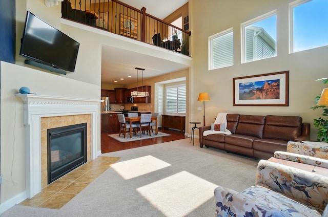 6368 Casado Dr, Columbus, OH 43213 - living area with a towering ceiling, baseboards, light carpet, and a fireplace