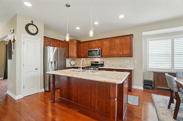 6368 Casado Dr, Columbus, OH 43213 - kitchen with appliances with stainless steel finishes, dark wood finished floors, light stone counters, hanging light fixtures, and recessed lighting