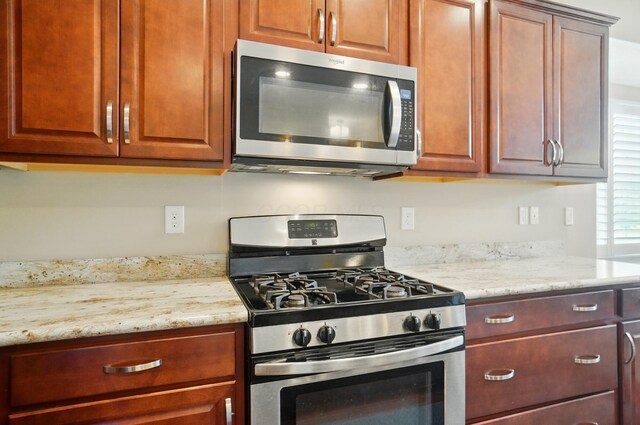 6368 Casado Dr, Columbus, OH 43213 - kitchen with appliances with stainless steel finishes and light stone countertops