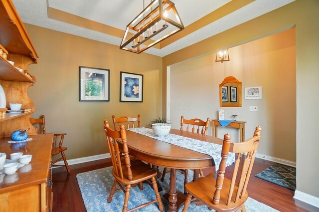 6368 Casado Dr, Columbus, OH 43213 - dining space with a chandelier, baseboards, and wood finished floors